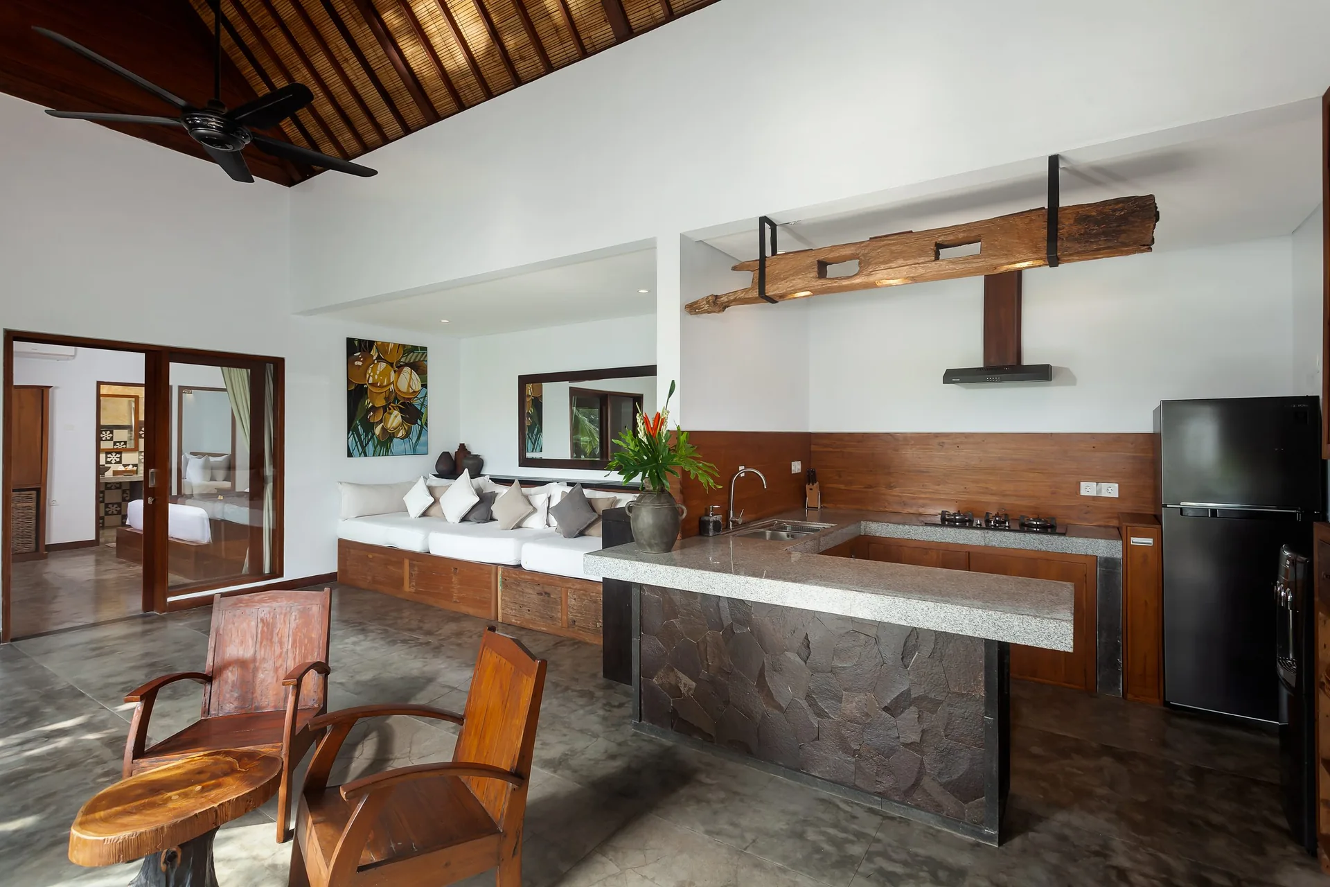 Stone-topped kitchen island, wooden cabinets and living space beneath a timber roof, 2-Bedroom Tranquility Villa at The Shea Ubud